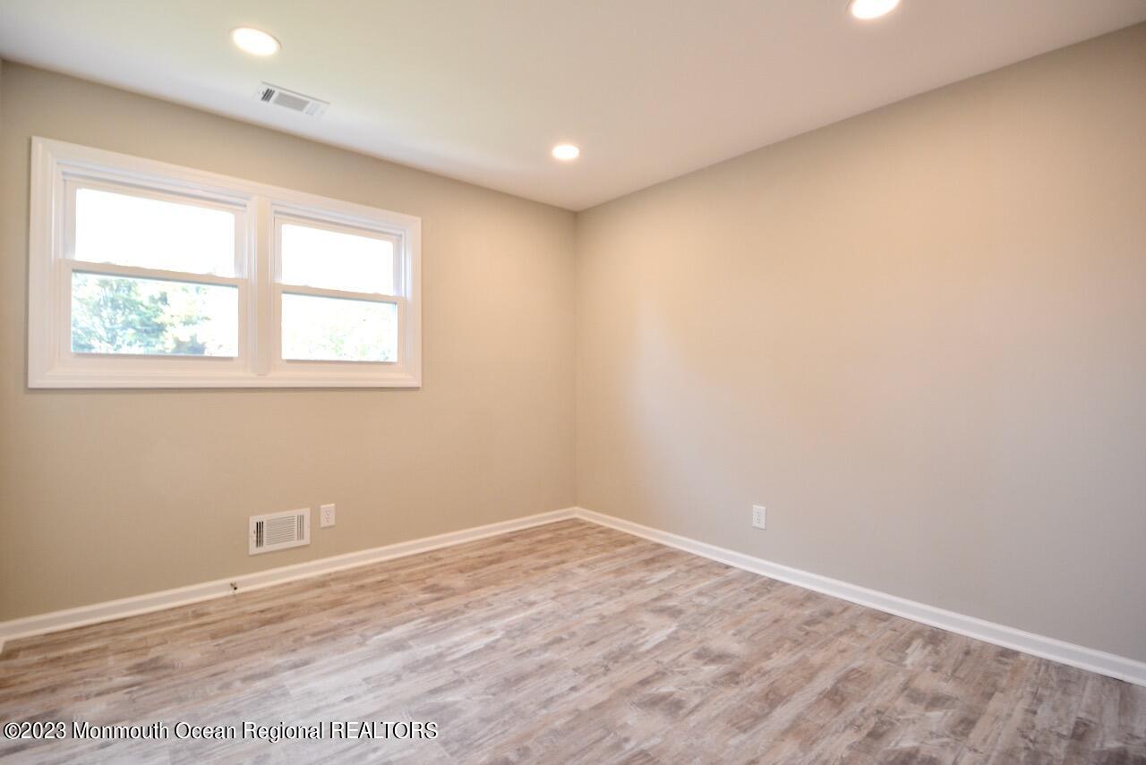6 Wickatunk Road Manalapan, NJ 07726 - Photo 33 of 35 an empty room with wooden floor and windows