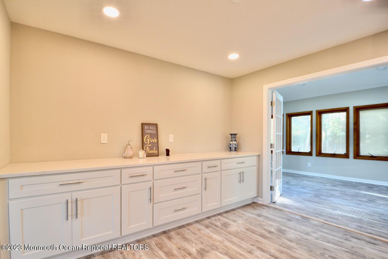 6 Wickatunk Road Manalapan, NJ 07726 - Photo 6 of 35 a spacious bathroom with a double vanity sink and a large mirror