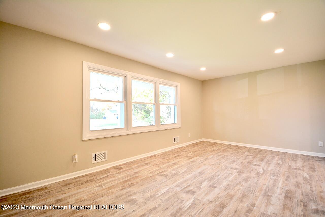 6 Wickatunk Road Manalapan, NJ 07726 - Photo 10 of 35 an empty room with wooden floor and windows