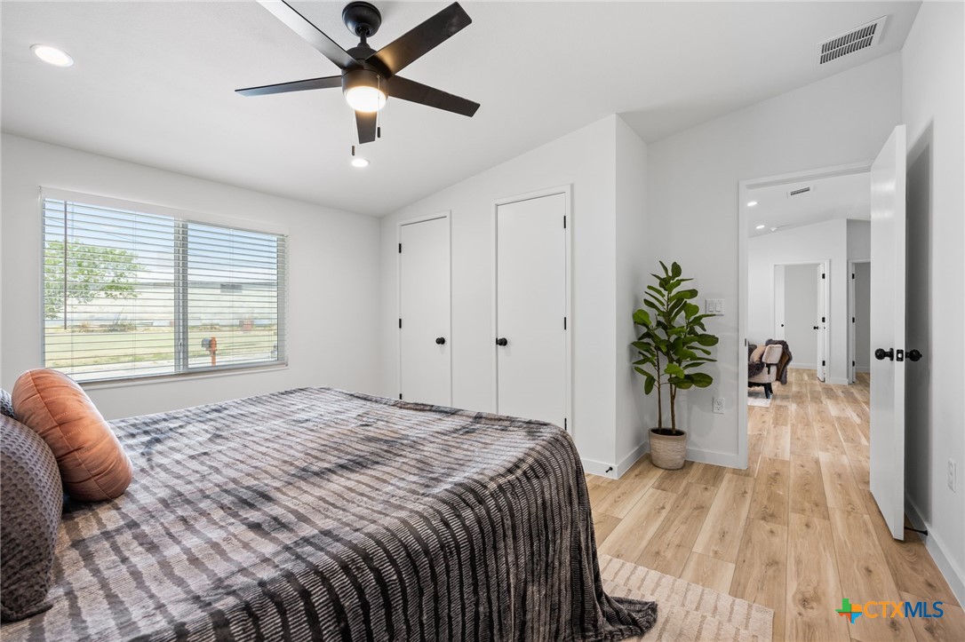 404 East Pecan Street Taylor, TX 76574 - Photo 11 of 19 a bed sitting in a spacious bedroom next to a window
