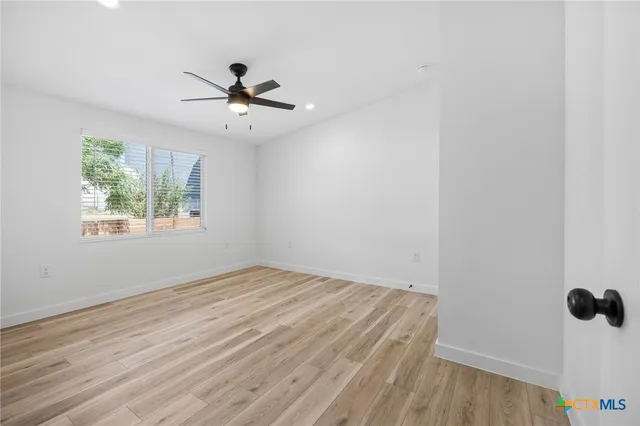 wooden floor in an empty room with a window