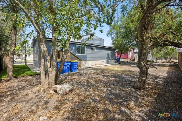 a view of a road with large trees