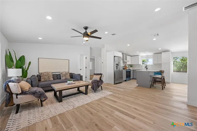 a living room with furniture and a wooden floor