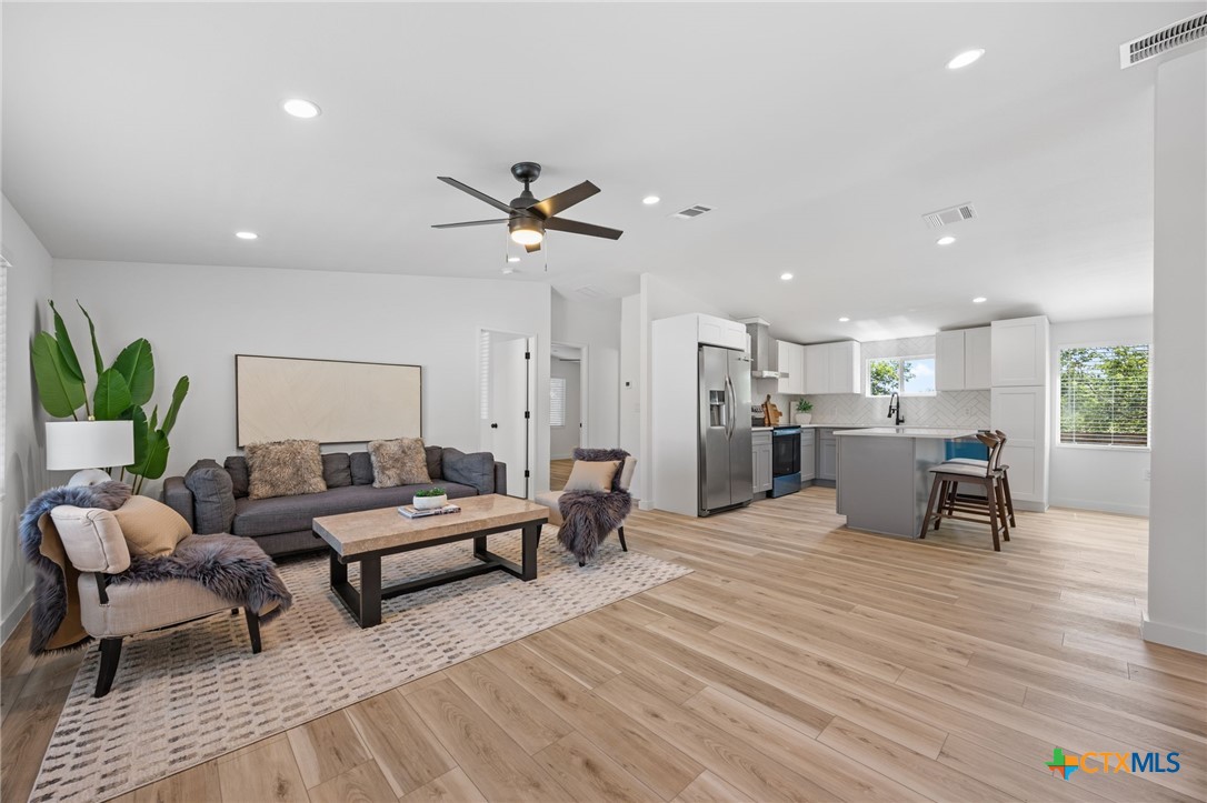 404 East Pecan Street Taylor, TX 76574 - Photo 3 of 19 a living room with furniture and a wooden floor