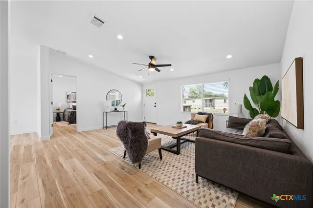 a living room with furniture and a large window