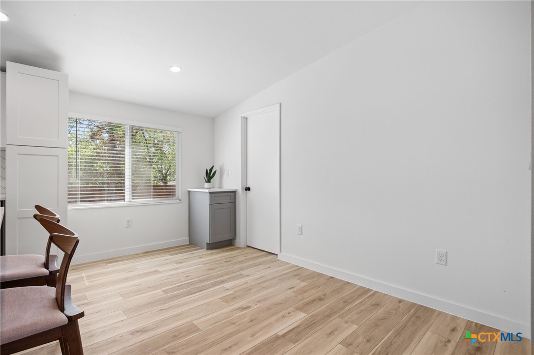 404 East Pecan Street Taylor, TX 76574 - Photo 9 of 19 a view of empty room with wooden floor and fan