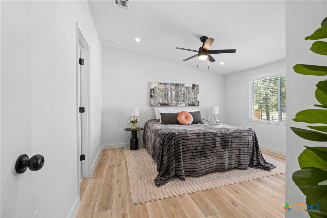 404 East Pecan Street Taylor, TX 76574 - Photo 10 of 19 a bedroom with a bed and window