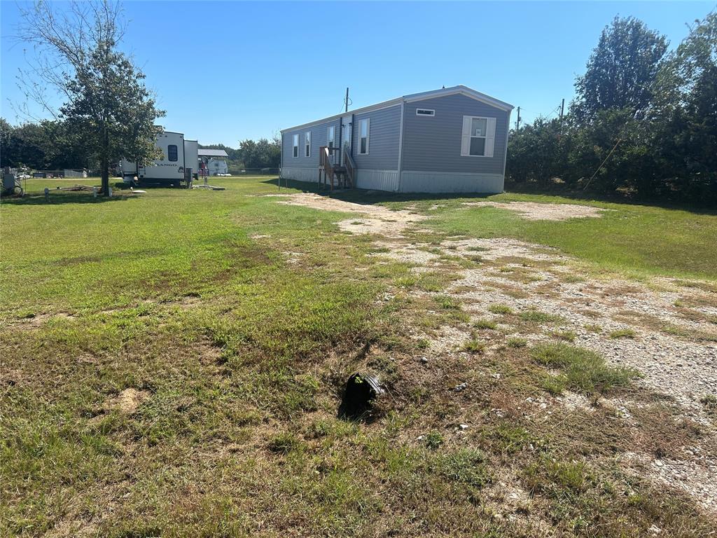 a house view with a big yard
