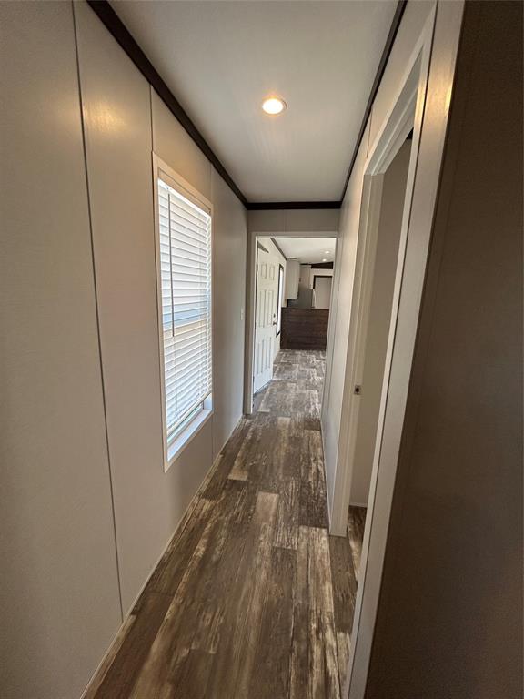 318 Seminole Quitman, TX 75783 - Photo 14 of 36 a view of hallway with a large window and wooden floor