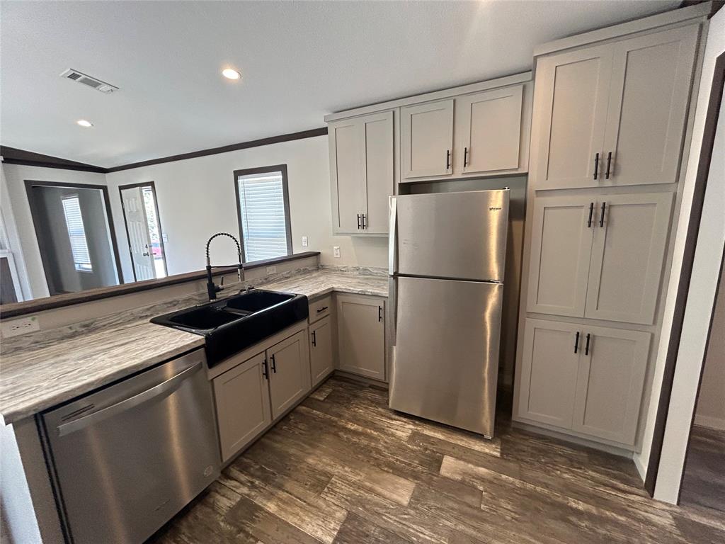 318 Seminole Quitman, TX 75783 - Photo 16 of 36 a kitchen with a refrigerator sink and cabinets