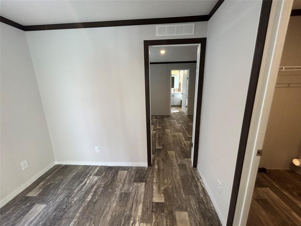 318 Seminole Quitman, TX 75783 - Photo 21 of 36 a view of a hallway with wooden floor and staircase