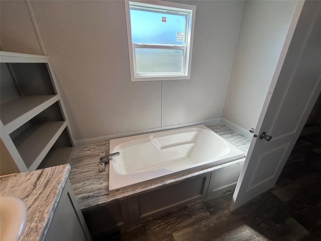 318 Seminole Quitman, TX 75783 - Photo 27 of 36 a view of room with window and wooden floor