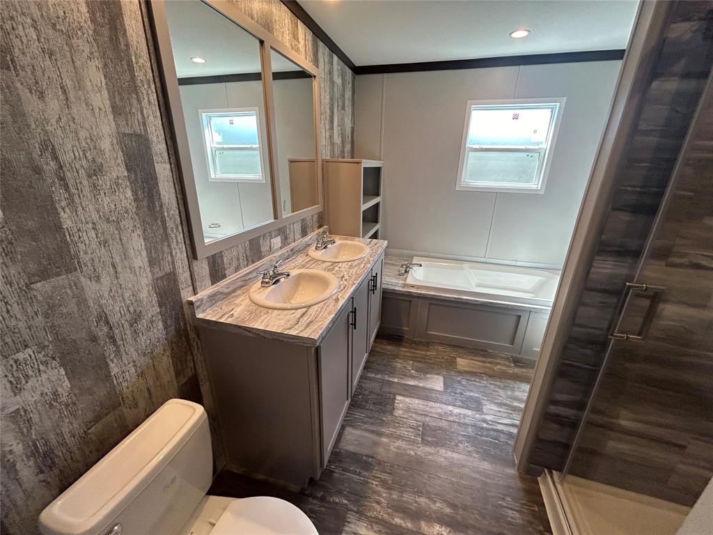 318 Seminole Quitman, TX 75783 - Photo 33 of 36 a bathroom with a sink a toilet and mirror