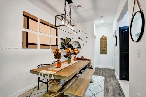 a kitchen with stainless steel appliances kitchen island granite countertop a refrigerator and a stove