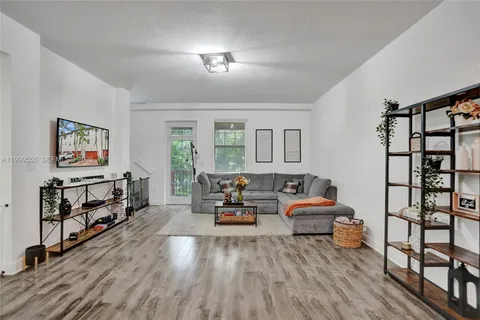 a living room with furniture a rug and a window