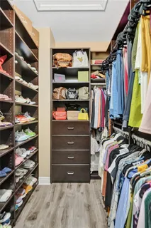 walk in closet with clothes and shoes