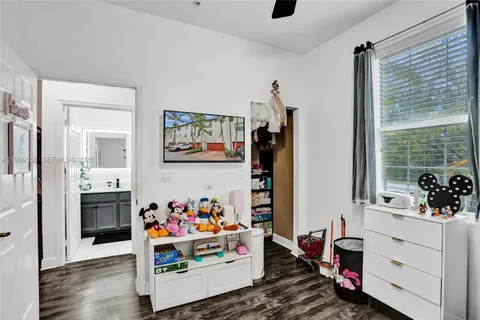 a room with furniture a rug toys and a window