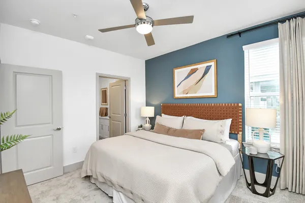 a bedroom with a bed and a large window
