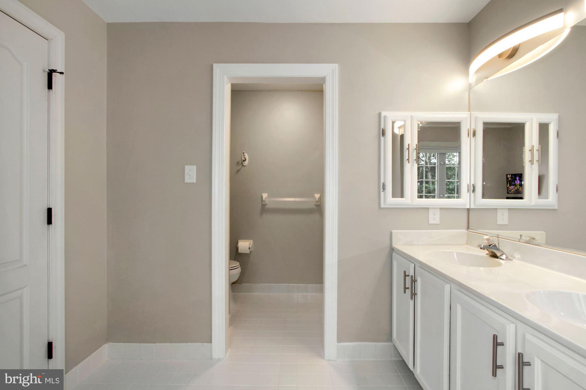 112 Federal Walk Kennett Square, PA 19348 - Photo 28 of 54 a spacious bathroom with a shower sink and mirror