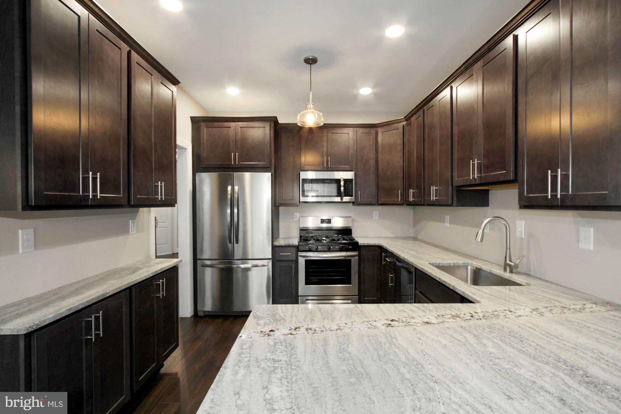 112 Federal Walk Kennett Square, PA 19348 - Photo 4 of 54 a kitchen with stainless steel appliances granite countertop a refrigerator and a sink