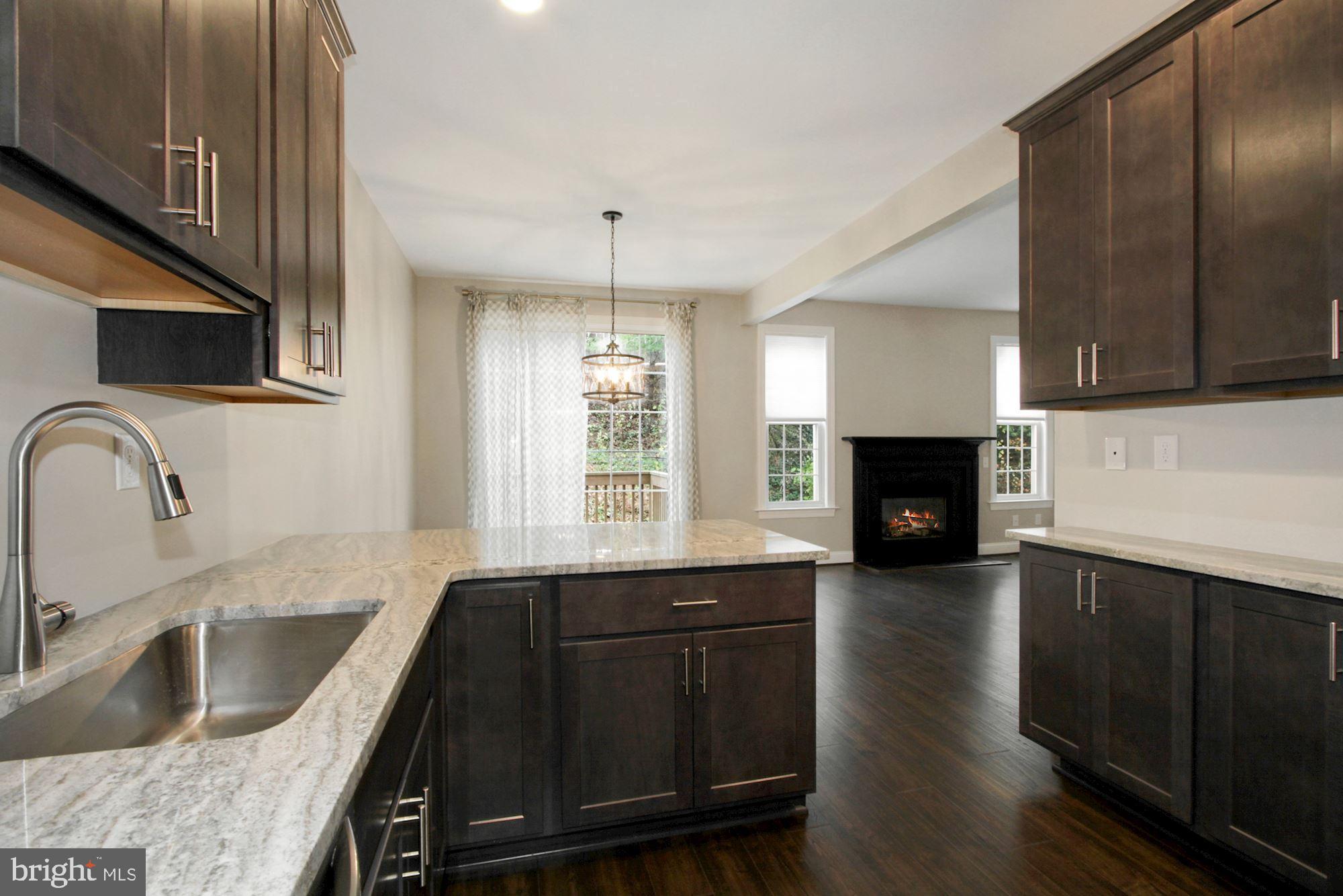 112 Federal Walk Kennett Square, PA 19348 - Photo 53 of 54 a kitchen with granite countertop a stove a sink and a microwave