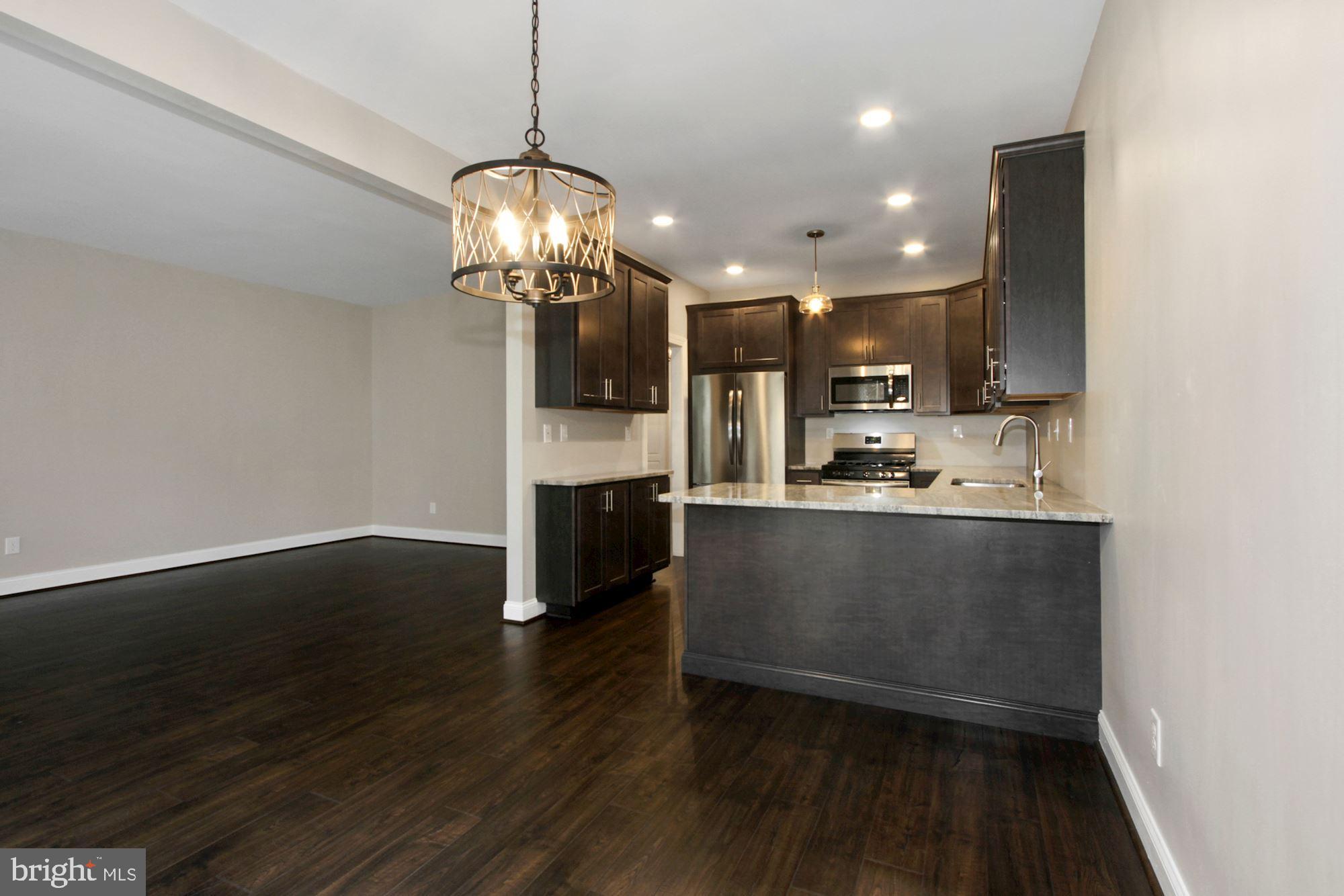 112 Federal Walk Kennett Square, PA 19348 - Photo 9 of 54 a view of kitchen and dining room with wooden floor