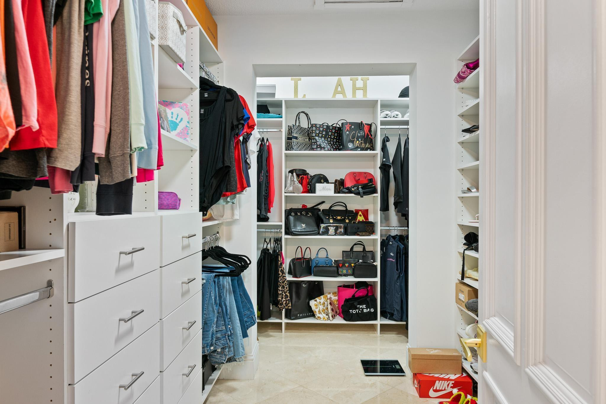 14540 Southwest 63rd Street Southwest Ranches, FL 33330 - Photo 19 of 69 a view of walk in closet with clothes and shoes