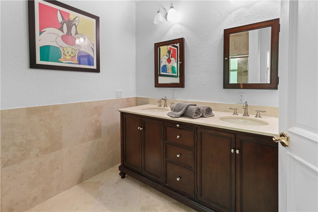 14540 Southwest 63rd Street Southwest Ranches, FL 33330 - Photo 49 of 69 a bathroom with a granite countertop double vanity sink and a mirror