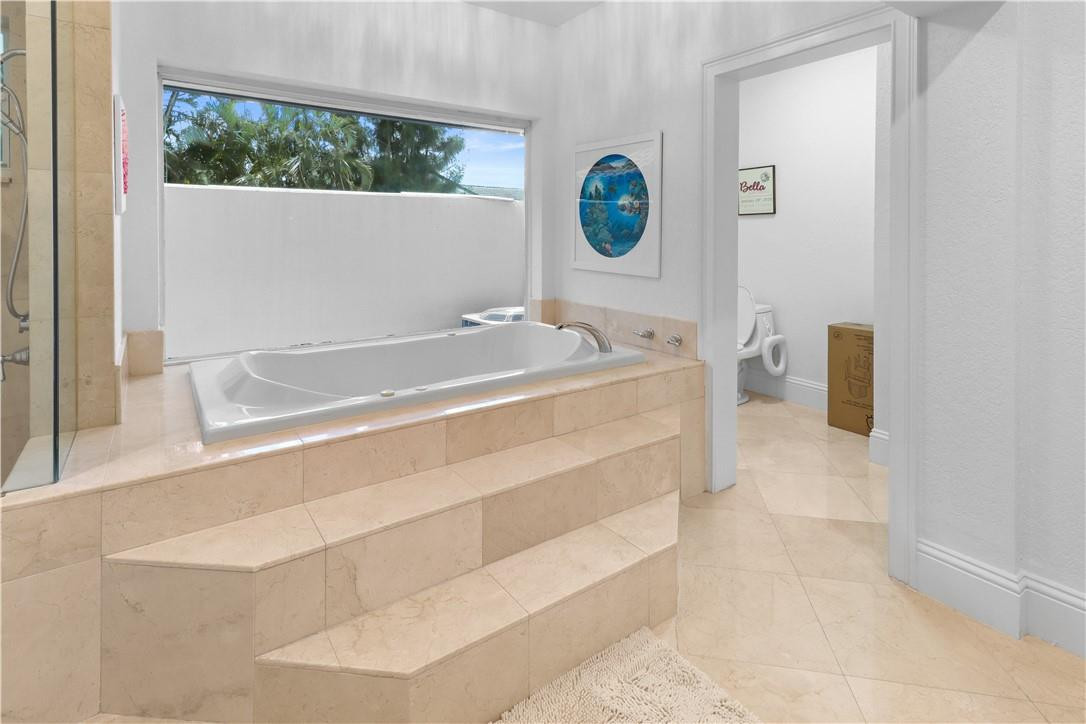 14540 Southwest 63rd Street Southwest Ranches, FL 33330 - Photo 50 of 69 a bath tub sitting next to a white sink
