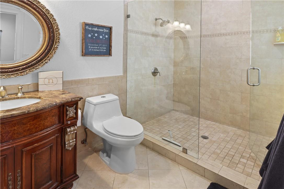 14540 Southwest 63rd Street Southwest Ranches, FL 33330 - Photo 52 of 69 a bathroom with a granite countertop toilet a sink and a mirror