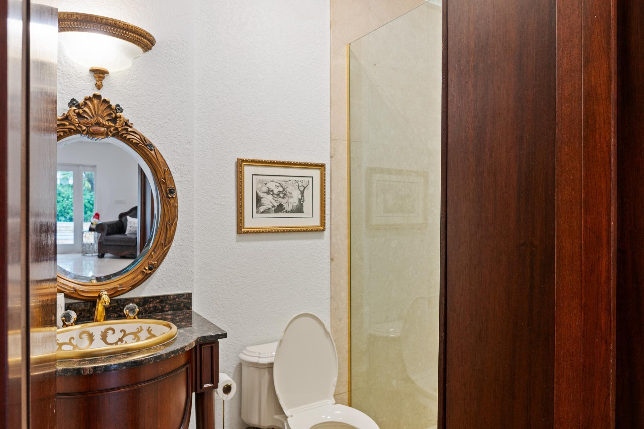 14540 Southwest 63rd Street Southwest Ranches, FL 33330 - Photo 53 of 69 a bathroom with a toilet a sink and mirror