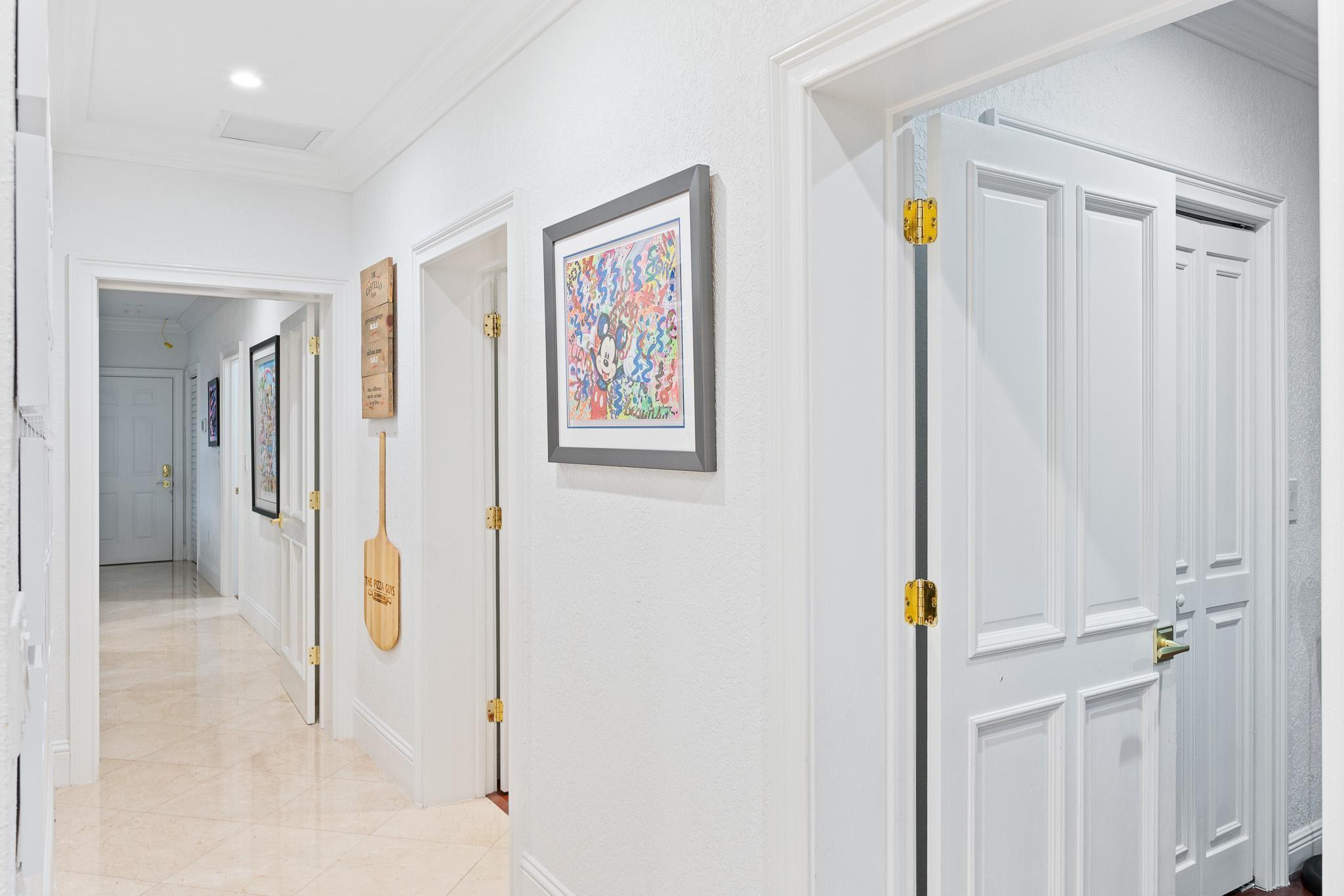 14540 Southwest 63rd Street Southwest Ranches, FL 33330 - Photo 57 of 69 a view of a hallway with paintings on the wall
