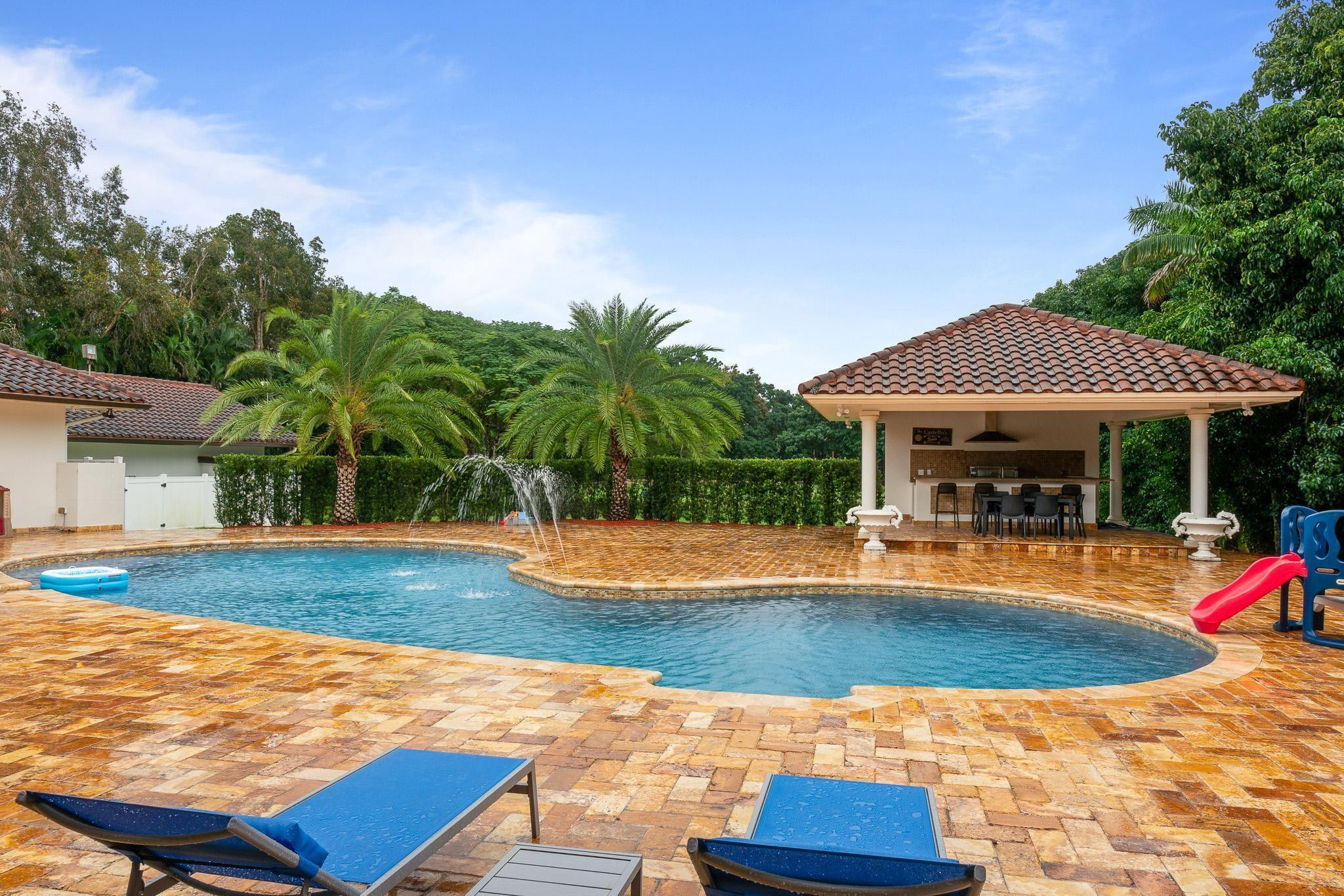 14540 Southwest 63rd Street Southwest Ranches, FL 33330 - Photo 60 of 69 a view of a house with swimming pool and sitting area