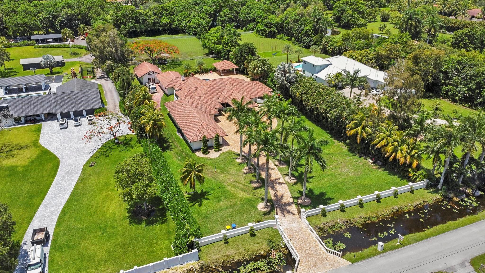 14540 Southwest 63rd Street Southwest Ranches, FL 33330 - Photo 68 of 69 an aerial view of a house with a garden and swimming pool