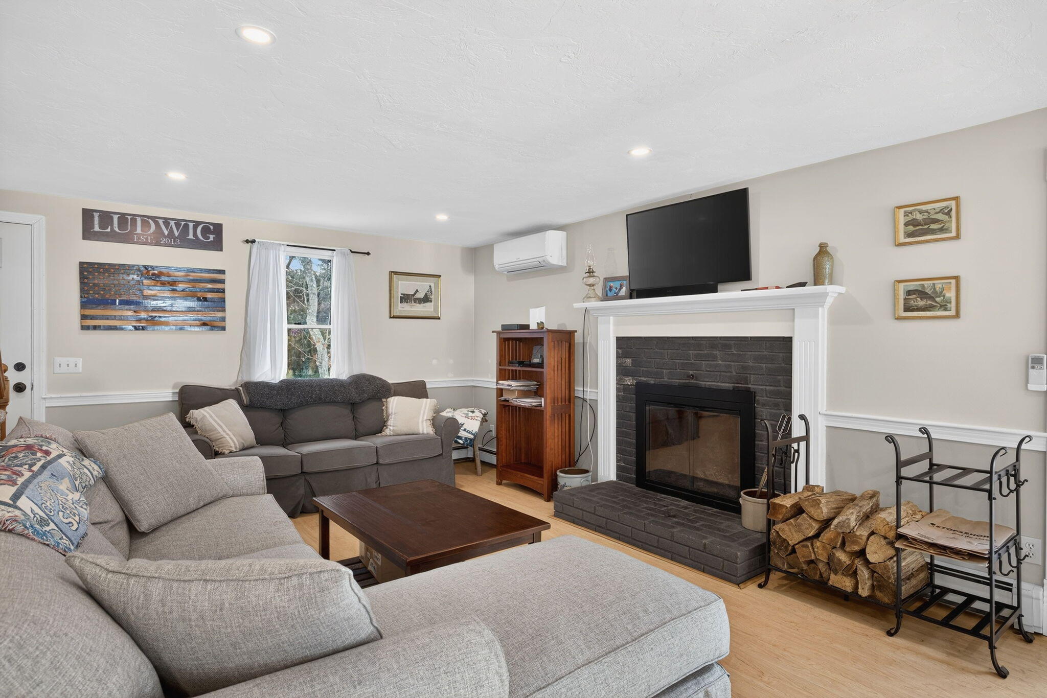 171 Weir Road Yarmouth Port, MA 02675 - Photo 14 of 53 a living room with furniture and a fireplace