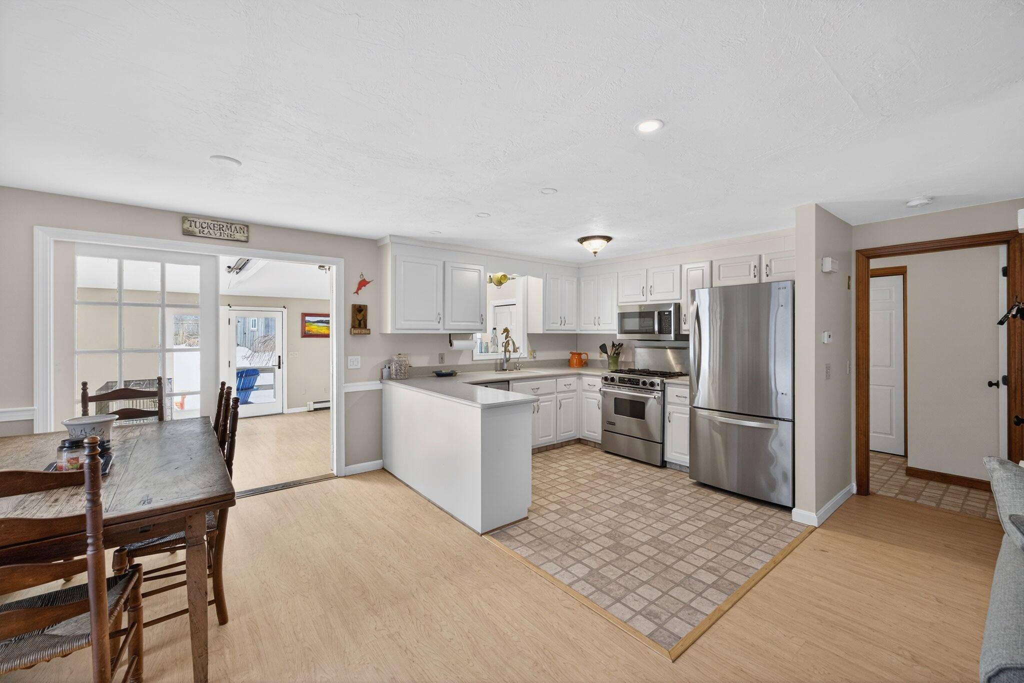 171 Weir Road Yarmouth Port, MA 02675 - Photo 3 of 53 a kitchen with a refrigerator a stove a sink a dining table and chairs