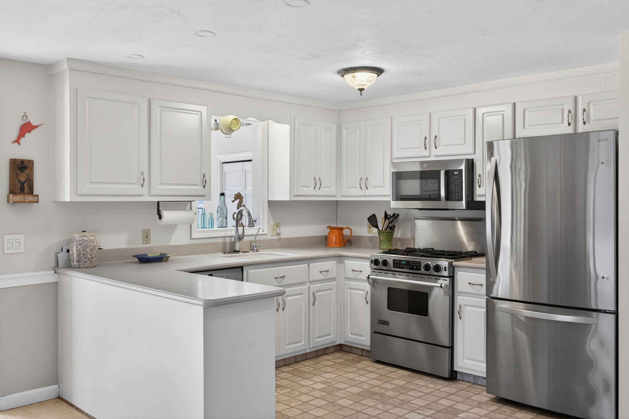 171 Weir Road Yarmouth Port, MA 02675 - Photo 4 of 53 a kitchen with white cabinets white stainless steel appliances and sink