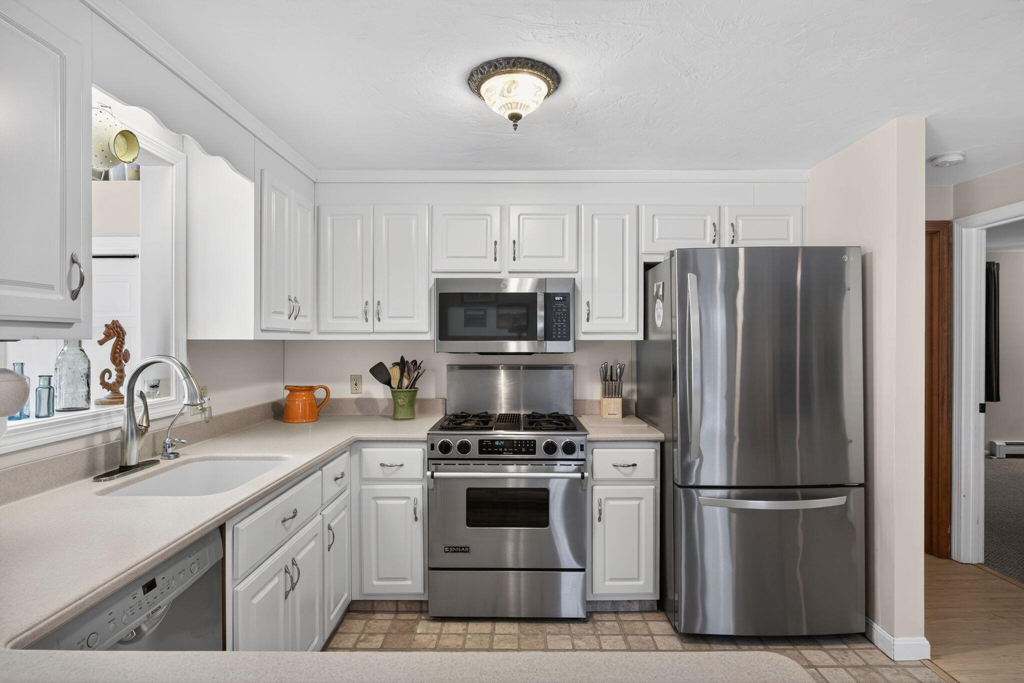 171 Weir Road Yarmouth Port, MA 02675 - Photo 6 of 53 a kitchen with stainless steel appliances a refrigerator sink and microwave