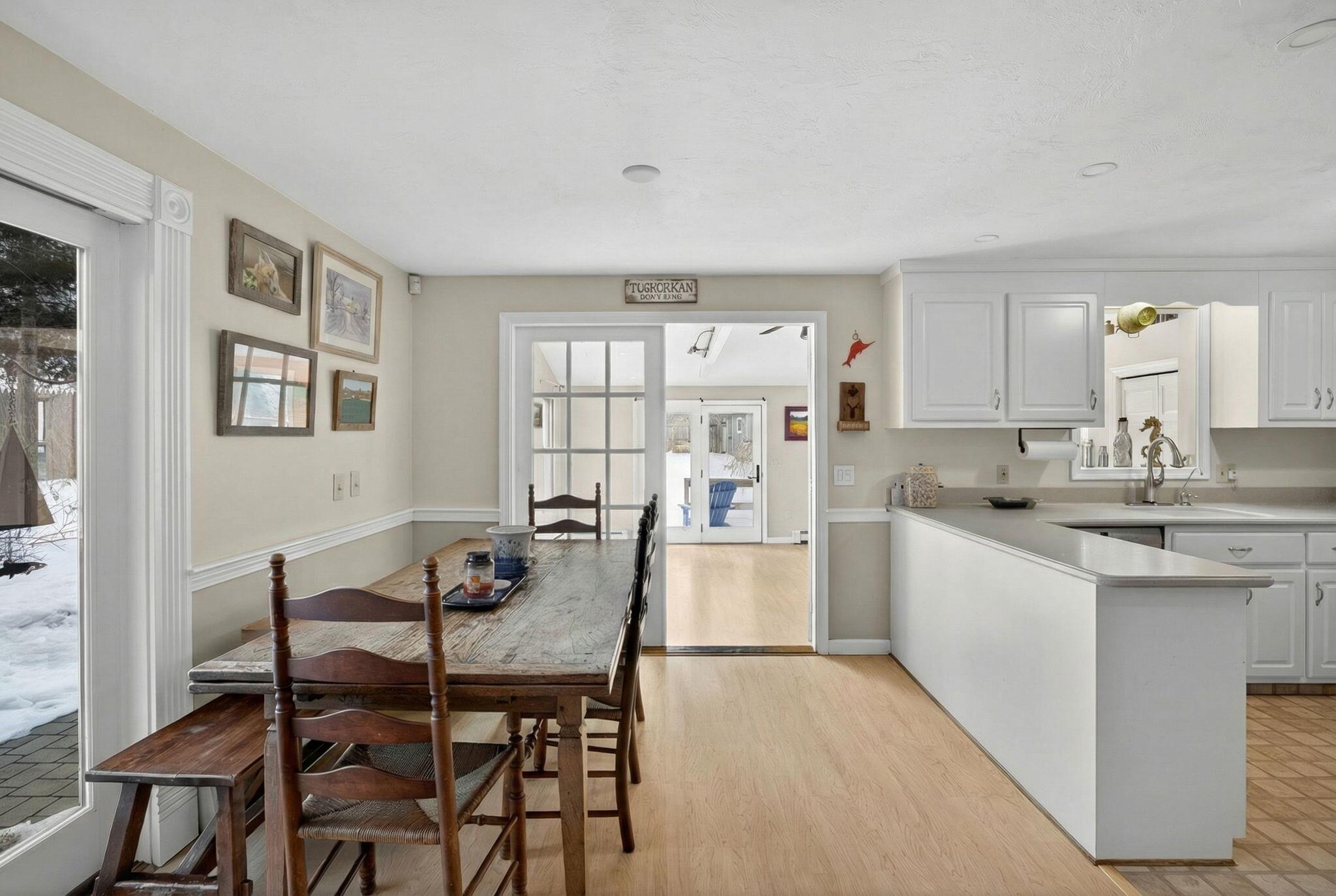 171 Weir Road Yarmouth Port, MA 02675 - Photo 8 of 53 a view of a dining room with furniture and wooden floor