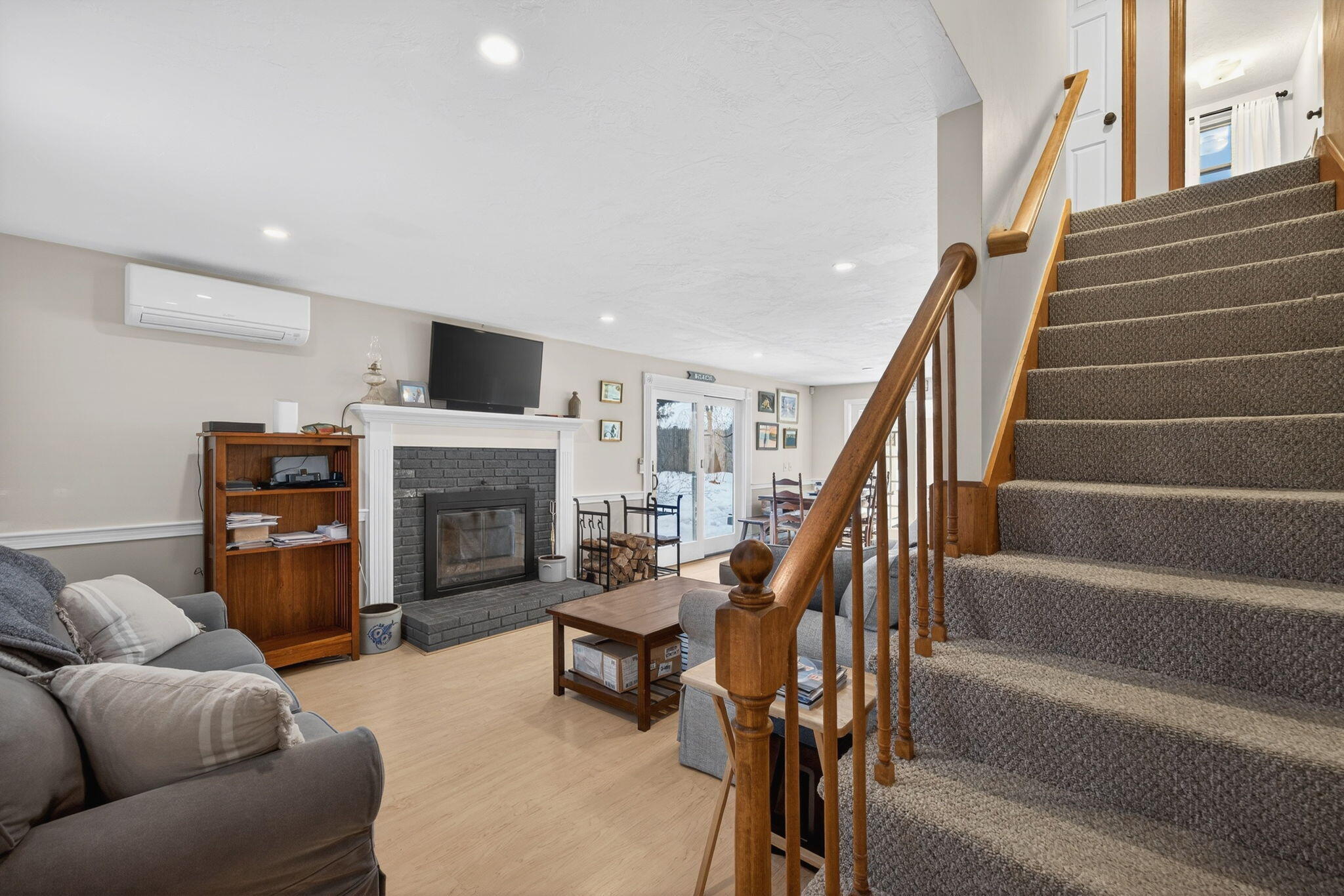 171 Weir Road Yarmouth Port, MA 02675 - Photo 9 of 53 a living room with furniture a fireplace and a flat screen tv