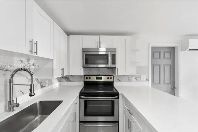 a kitchen with granite countertop a stove and a sink