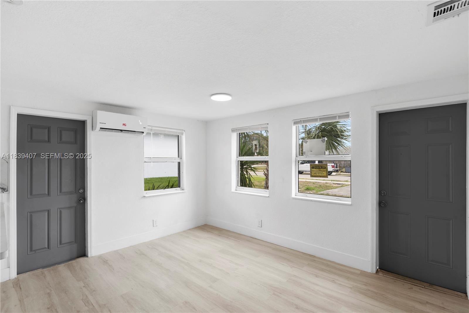 607 Southwest 3rd Street, Unit 1 Delray Beach, FL 33444 - Photo 15 of 27 an empty room with windows and closet