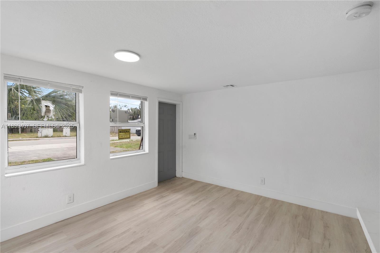 607 Southwest 3rd Street, Unit 1 Delray Beach, FL 33444 - Photo 16 of 27 an empty room with windows