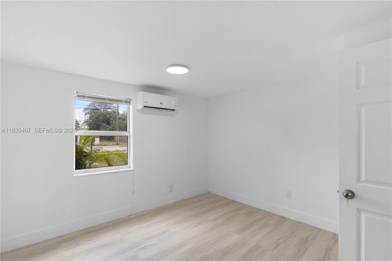 607 Southwest 3rd Street, Unit 1 Delray Beach, FL 33444 - Photo 18 of 27 an empty room with a window