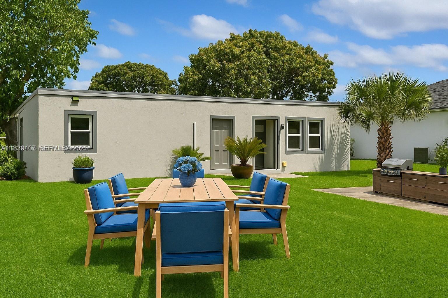 607 Southwest 3rd Street, Unit 1 Delray Beach, FL 33444 - Photo 2 of 27 a backyard of a house with table and chairs