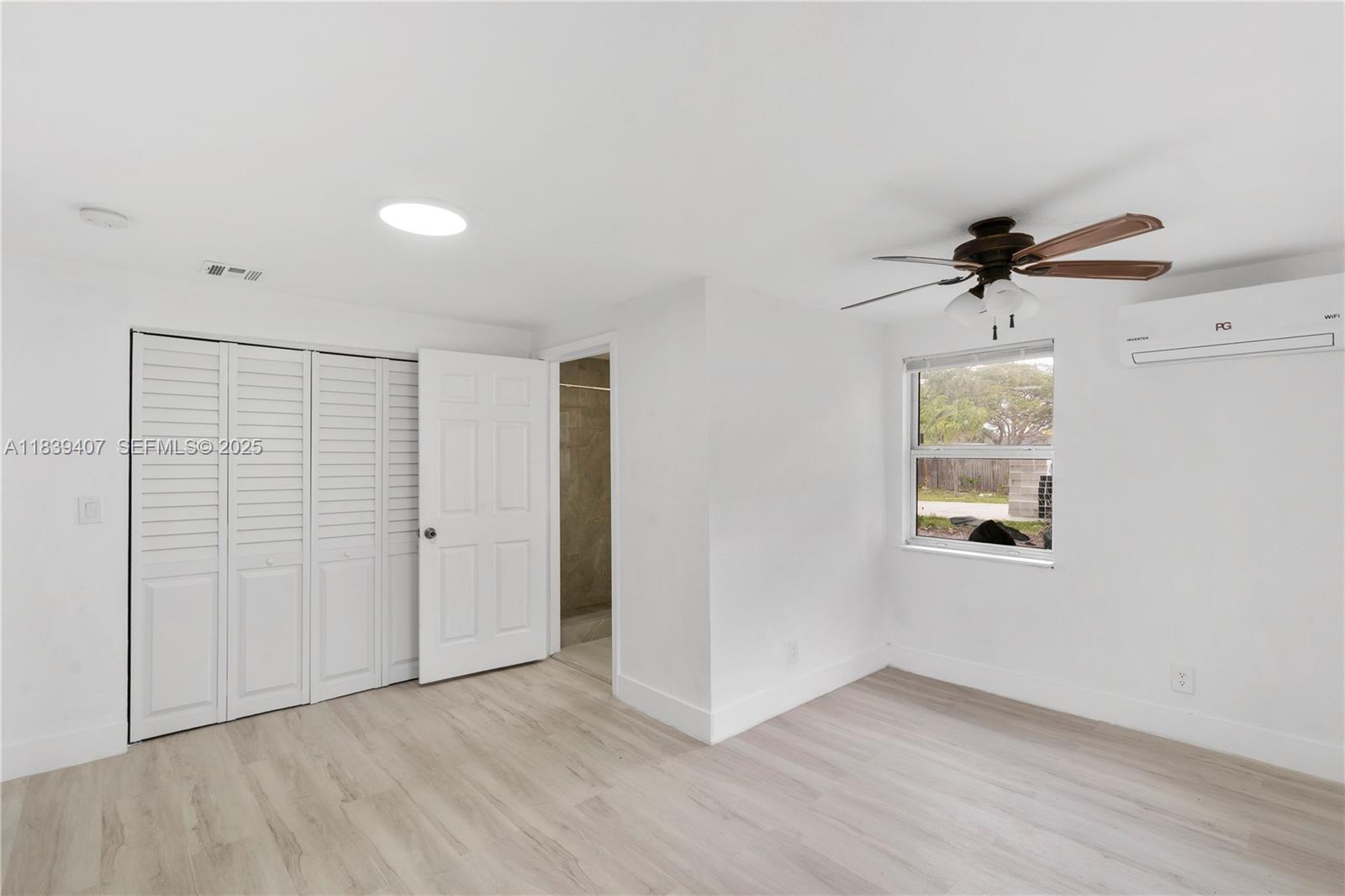 607 Southwest 3rd Street, Unit 1 Delray Beach, FL 33444 - Photo 24 of 27 wooden floor in an empty room with a window
