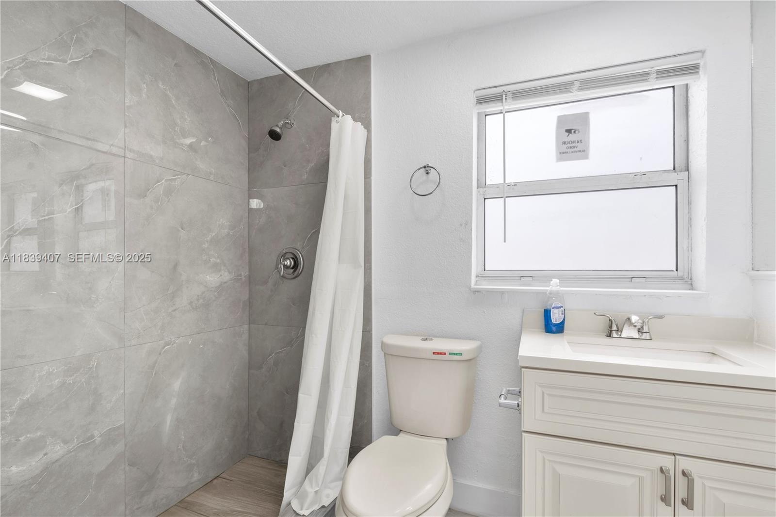 607 Southwest 3rd Street, Unit 1 Delray Beach, FL 33444 - Photo 26 of 27 a bathroom with a sink a toilet and shower
