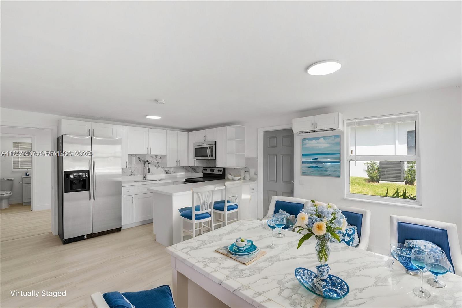 607 Southwest 3rd Street, Unit 1 Delray Beach, FL 33444 - Photo 4 of 27 a living room with stainless steel appliances kitchen island granite countertop furniture and a kitchen view