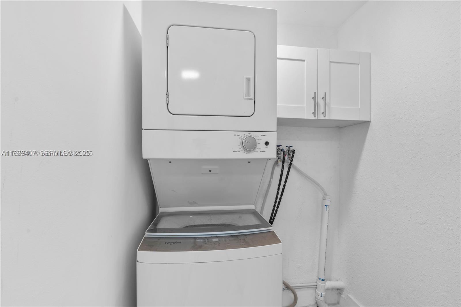 607 Southwest 3rd Street, Unit 1 Delray Beach, FL 33444 - Photo 7 of 27 a utility room with dryer and washer