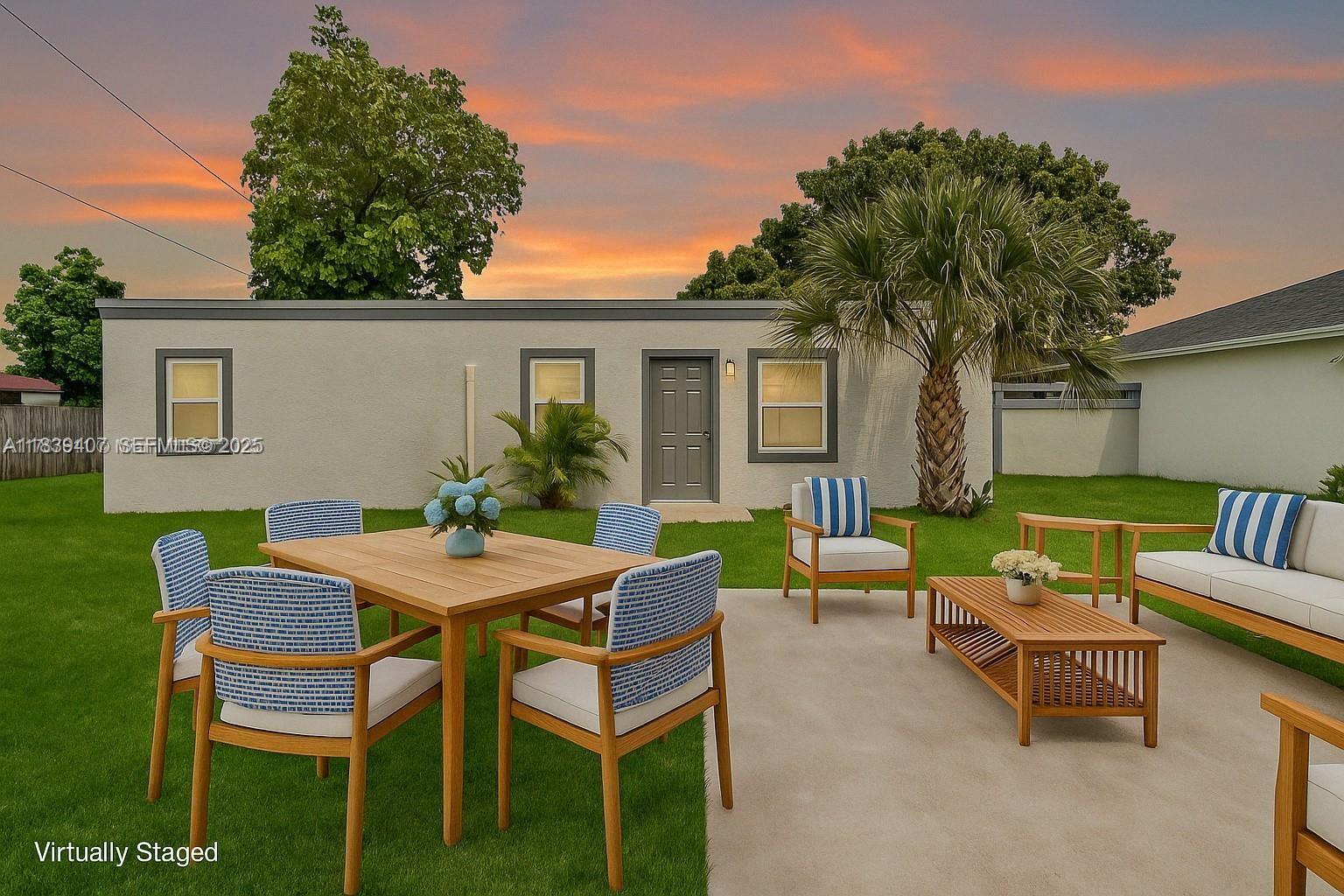 607 Southwest 3rd Street, Unit 1 Delray Beach, FL 33444 - Photo 10 of 27 a view of a patio with table and chairs and potted plants